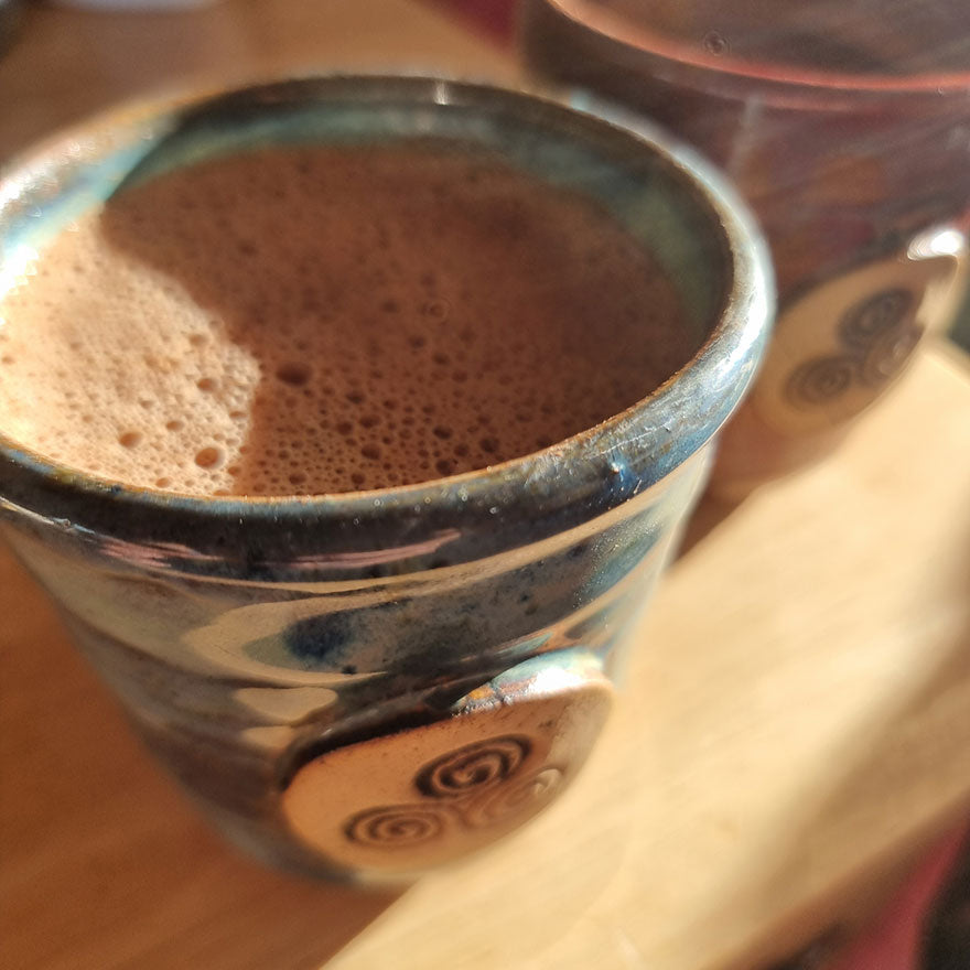 ceremonial cup with virgin ceremonial cacao in the sun
