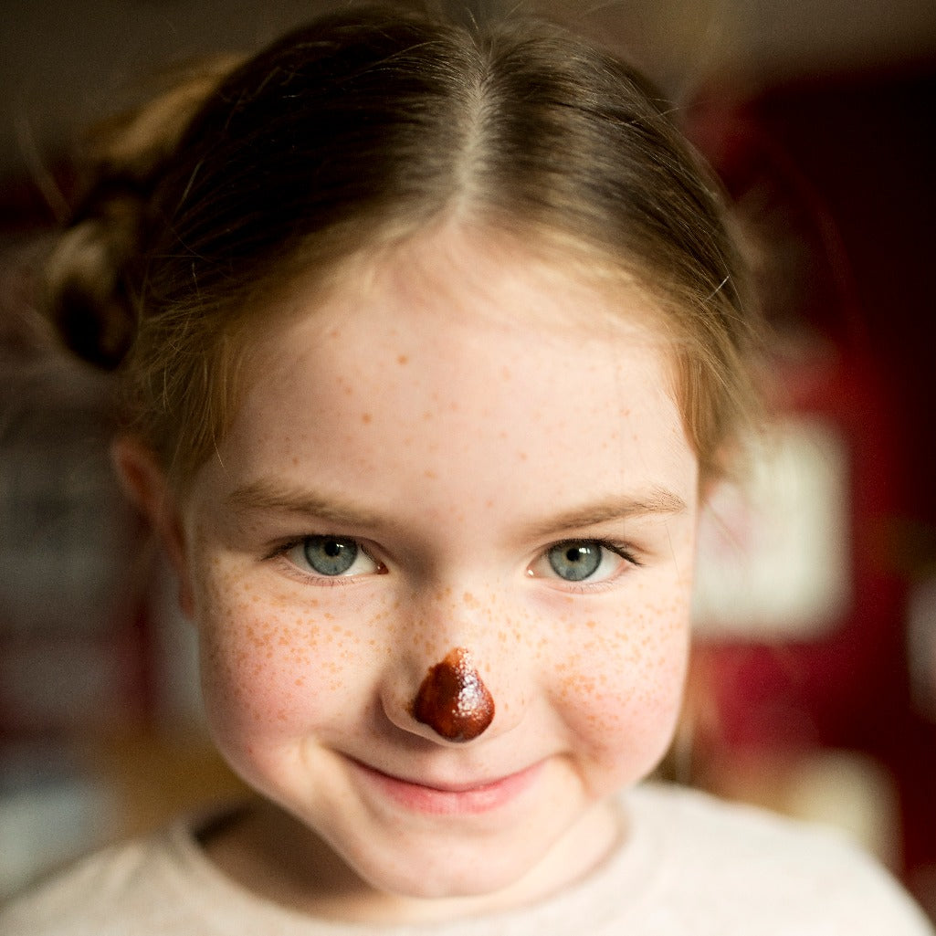 child with a chocolate nose