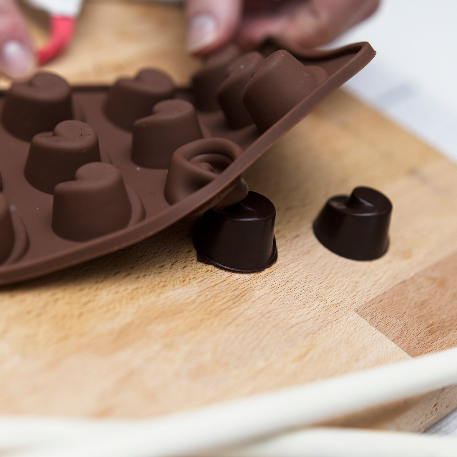popping set chocolates from a mould