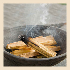 palo santo burning in bowl