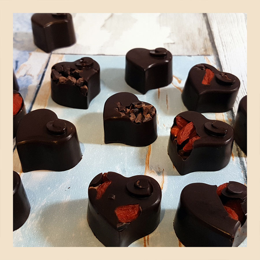 raw chocolate hearts with goji berries and cacao nibs